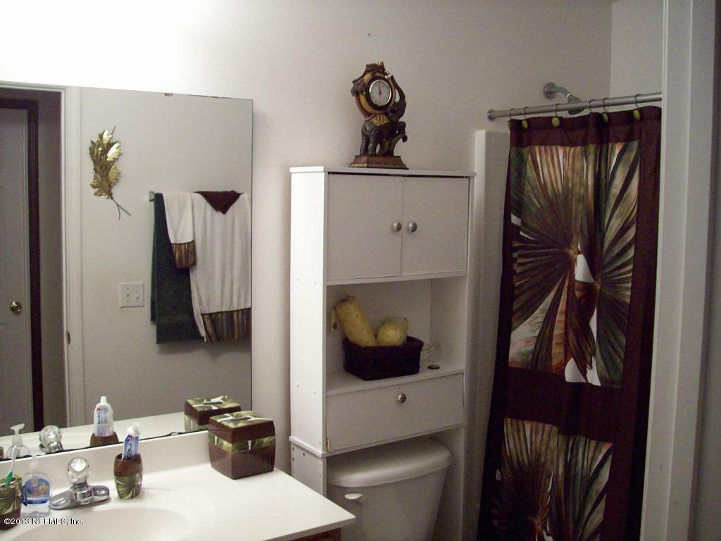 9183 Raptor Drive Jacksonville, FL 32221 - Photo 8 of 13 a bathroom with a sink and mirror