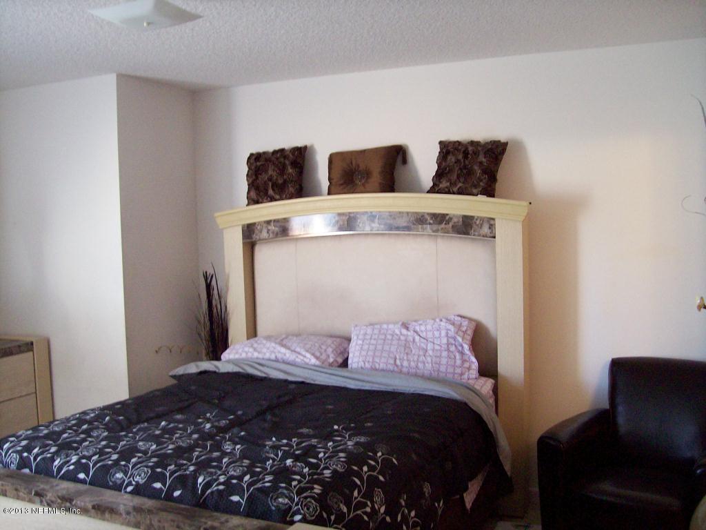 9183 Raptor Drive Jacksonville, FL 32221 - Photo 10 of 13 a bedroom with a bed and a couch
