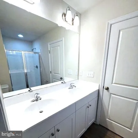 a bathroom with a sink vanity and a mirror
