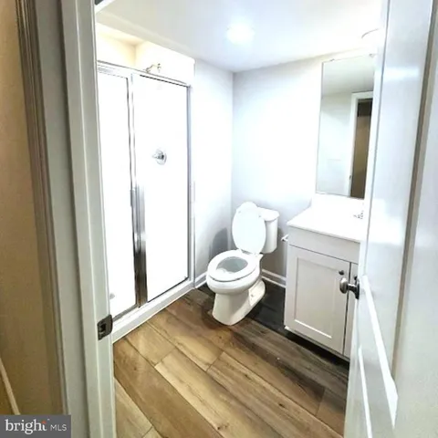 a bathroom with a toilet and a shower