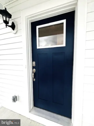 a hallway with a door and a mirror