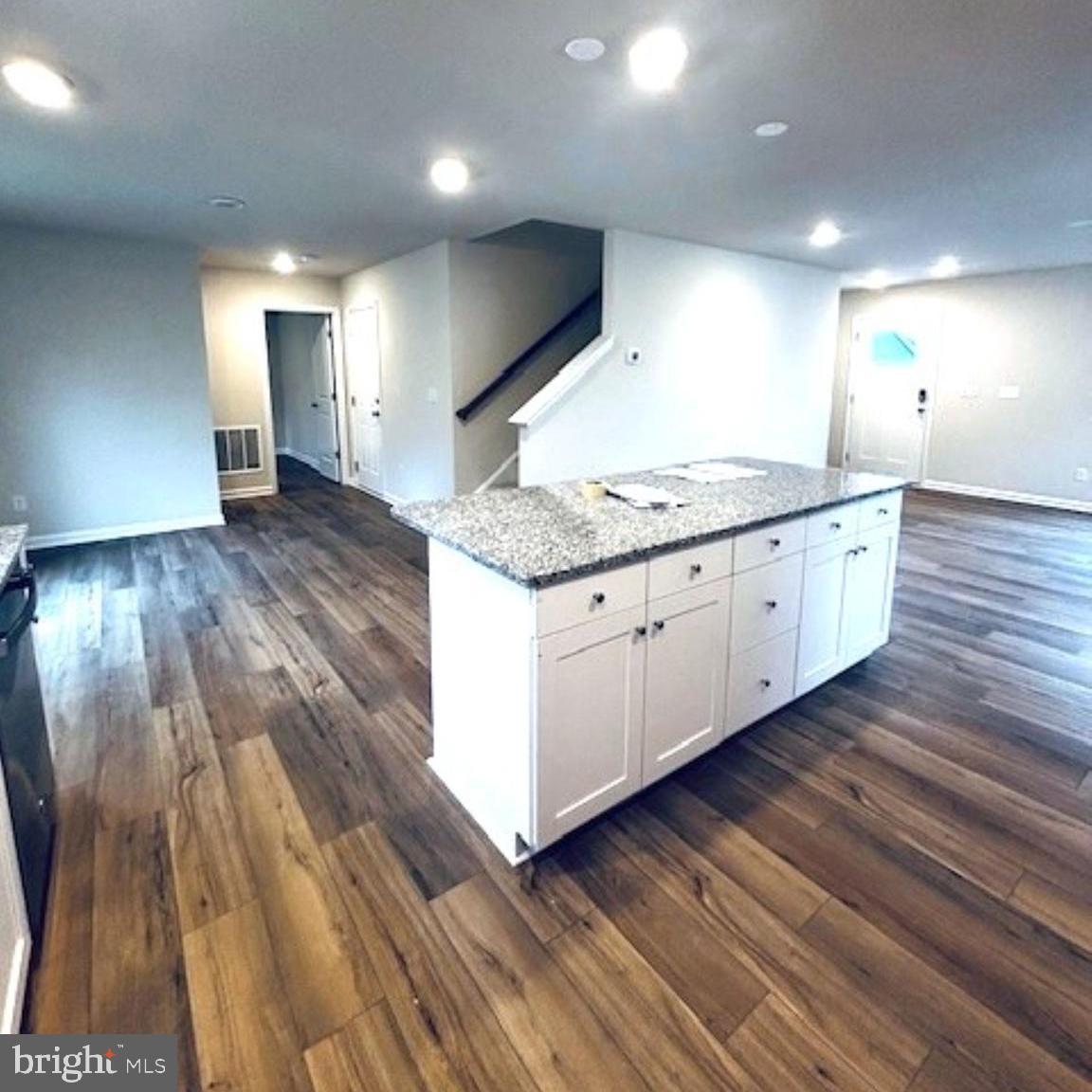 719 R Wilson Loop Georgetown, DE 19947 - Photo 3 of 17 a large kitchen with stainless steel appliances granite countertop a large counter top and a wooden floors