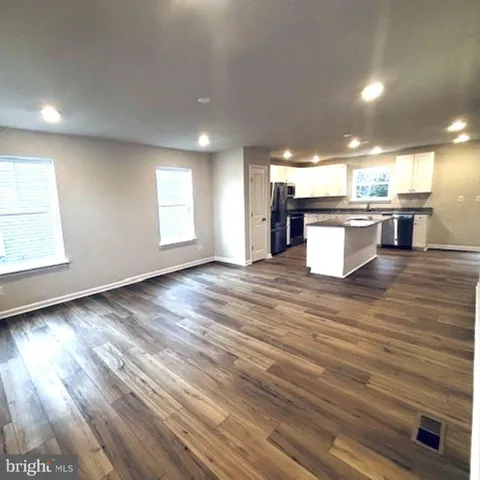 an open kitchen with a sink and window