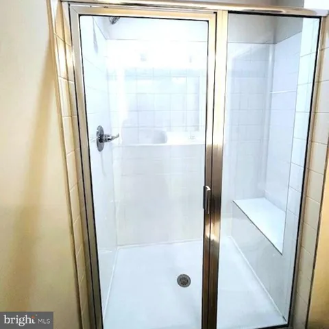 a bathroom with a glass shower door