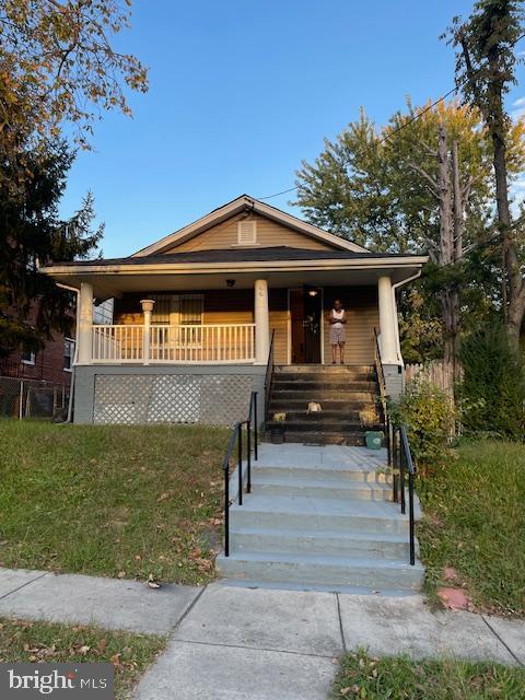 66 53rd Place Southeast Washington, DC 20019 - Photo 8 of 9 a front view of a house with a garden