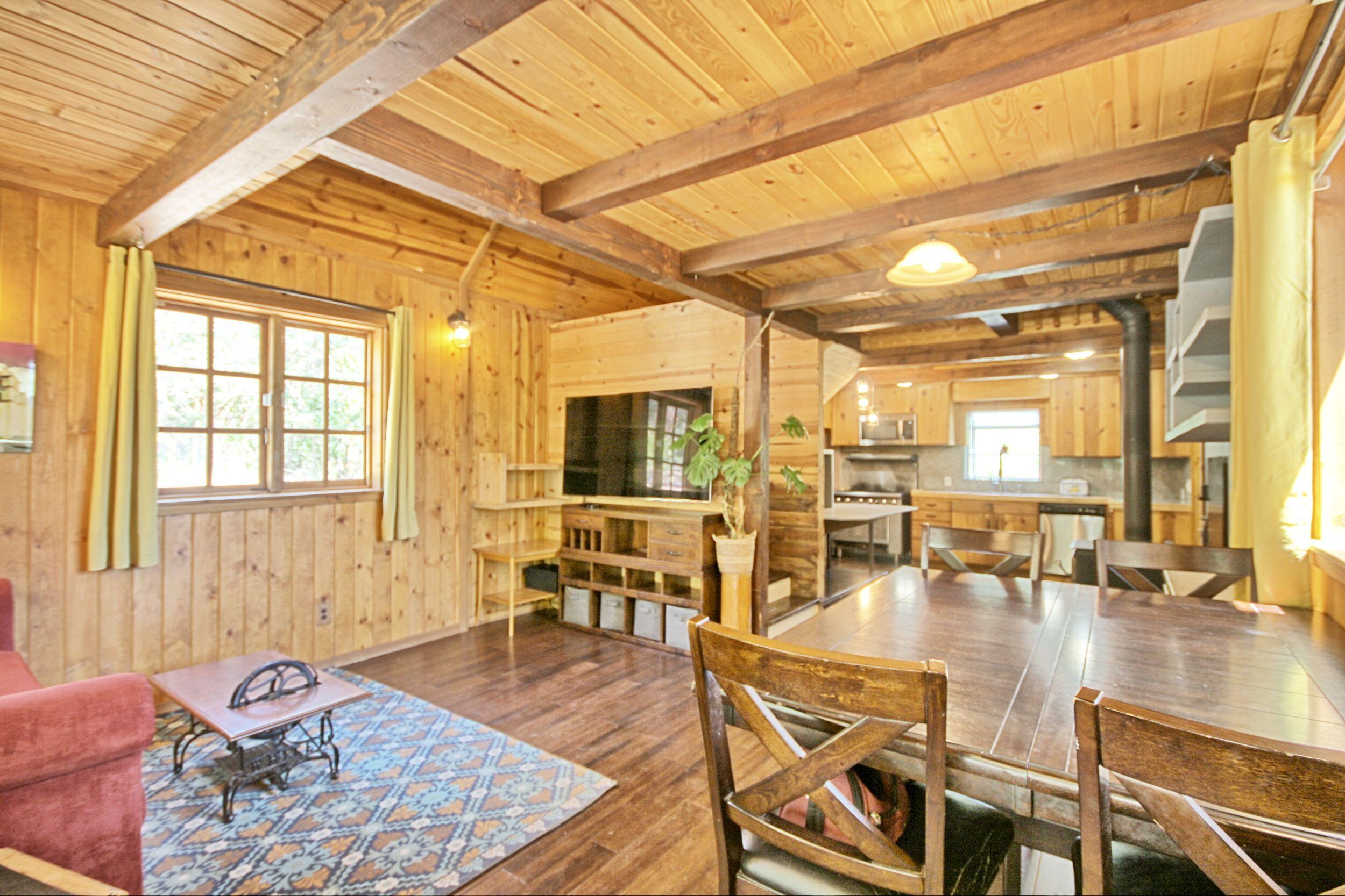 2231 Humbug Creek Road Jacksonville, OR 97530 - Photo 15 of 80 a living room with lots of furniture and wooden floor