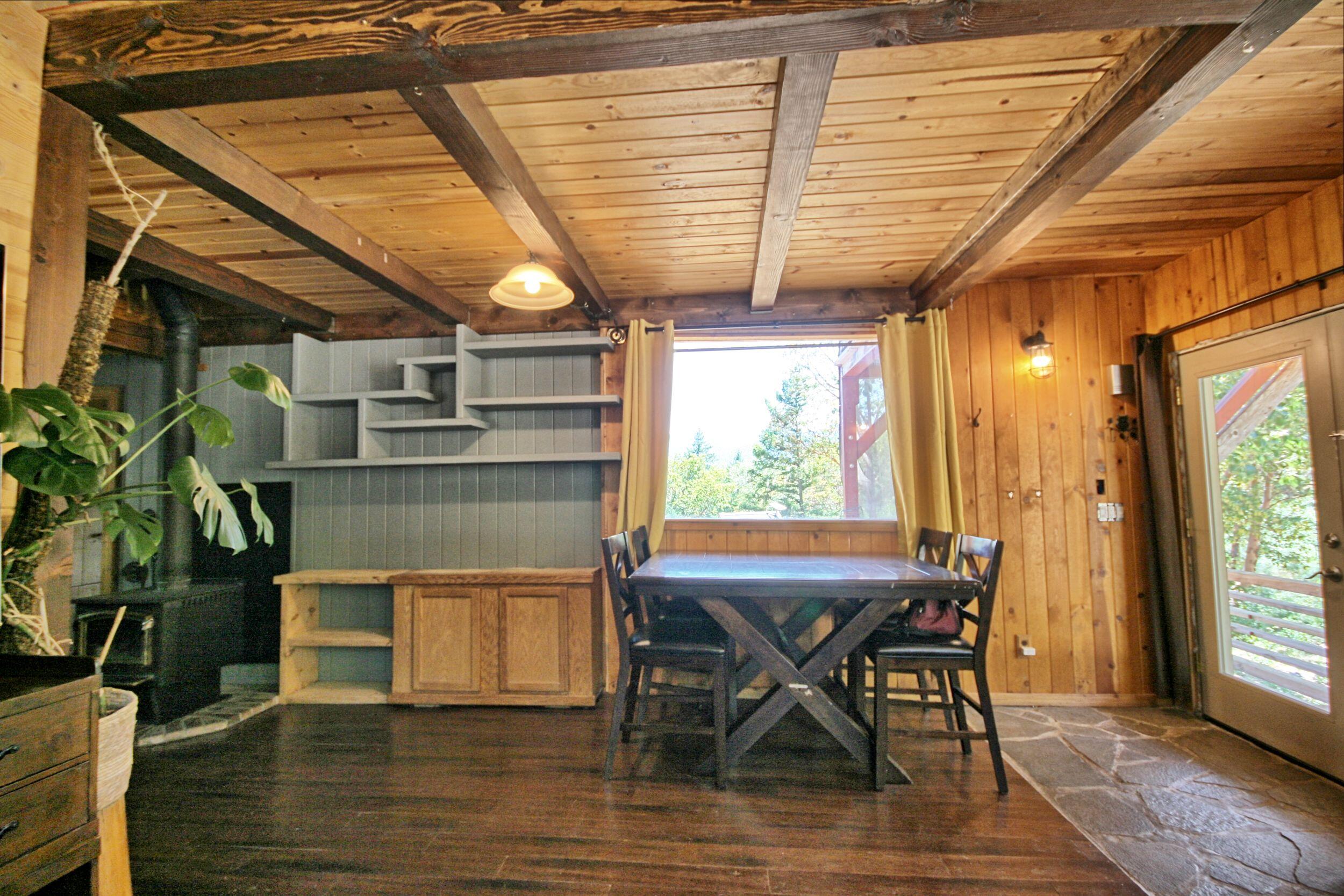 2231 Humbug Creek Road Jacksonville, OR 97530 - Photo 17 of 80 a view of a dining room with furniture window and wooden floor