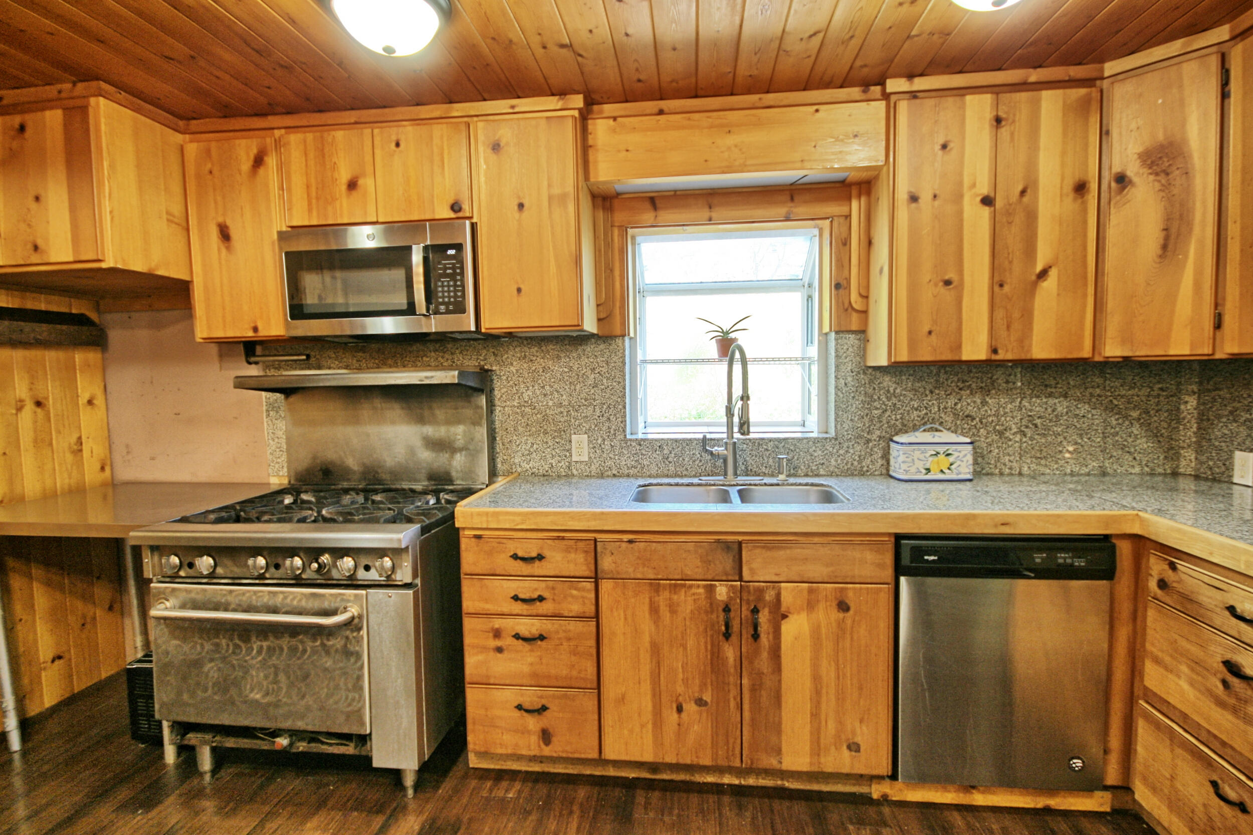 2231 Humbug Creek Road Jacksonville, OR 97530 - Photo 23 of 80 a kitchen with stainless steel appliances granite countertop a stove a sink and a microwave