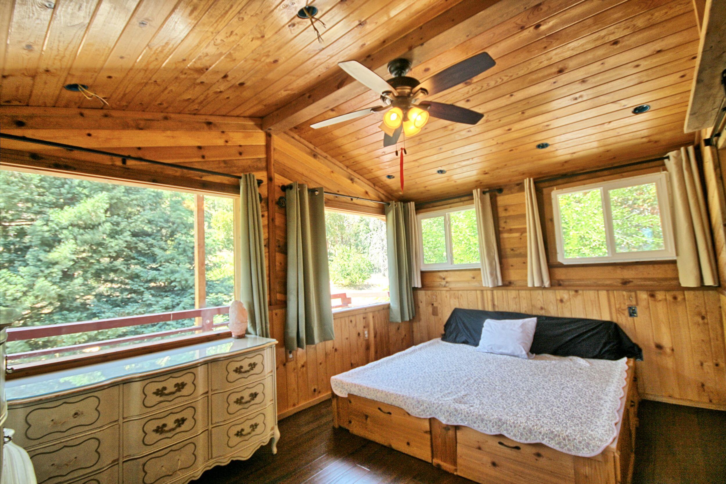 2231 Humbug Creek Road Jacksonville, OR 97530 - Photo 33 of 80 a bedroom with a bed dresser and a window