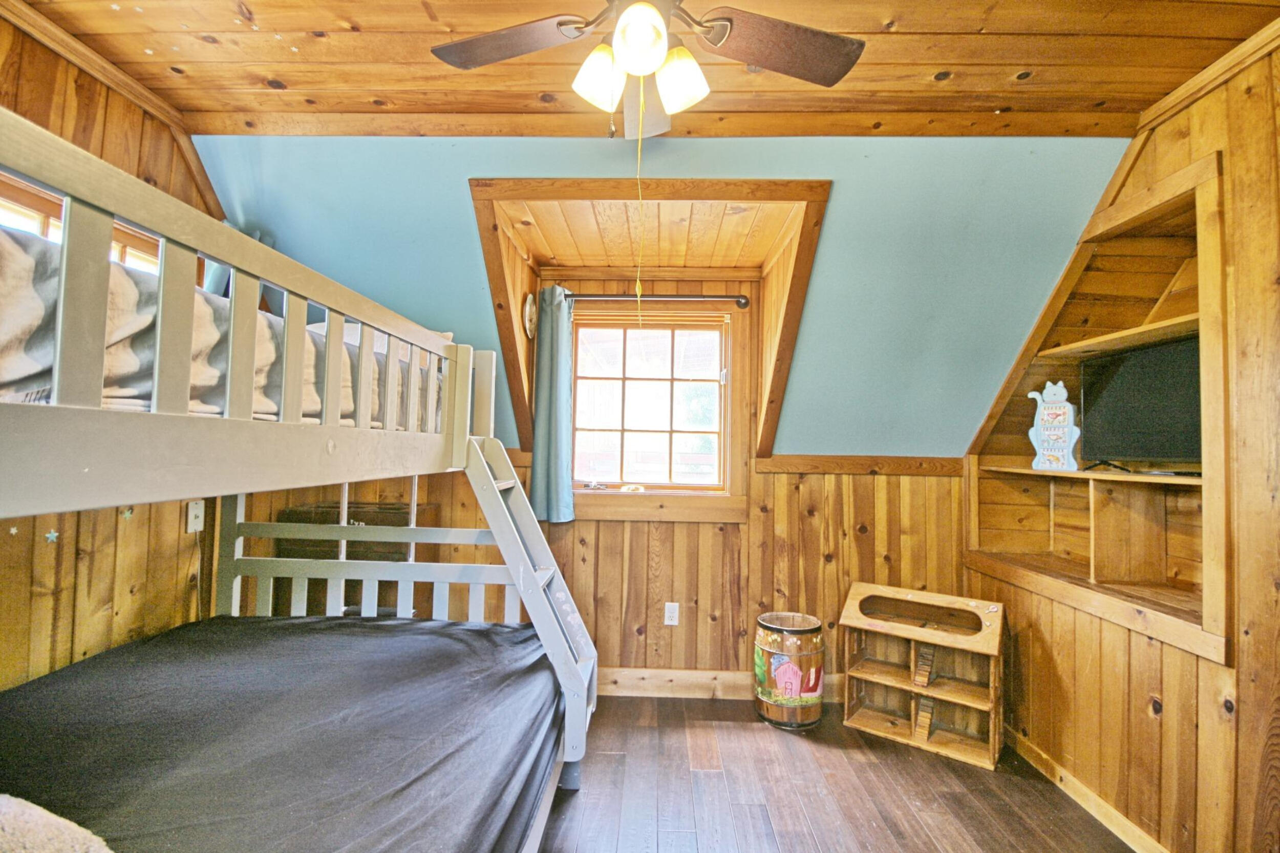 2231 Humbug Creek Road Jacksonville, OR 97530 - Photo 42 of 80 a view of a bedroom with wooden floor and windows