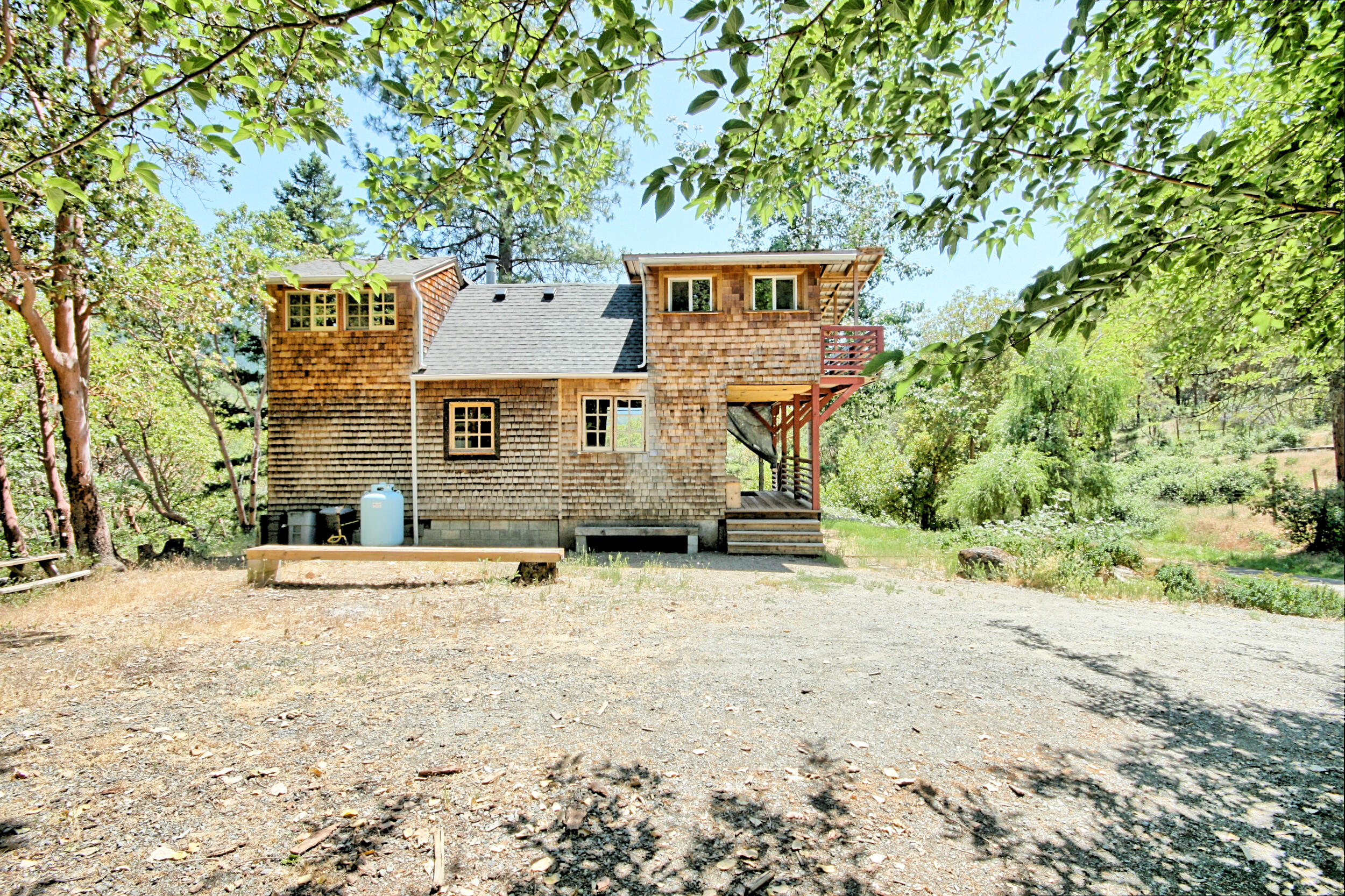 2231 Humbug Creek Road Jacksonville, OR 97530 - Photo 46 of 80 a front view of a house with a yard