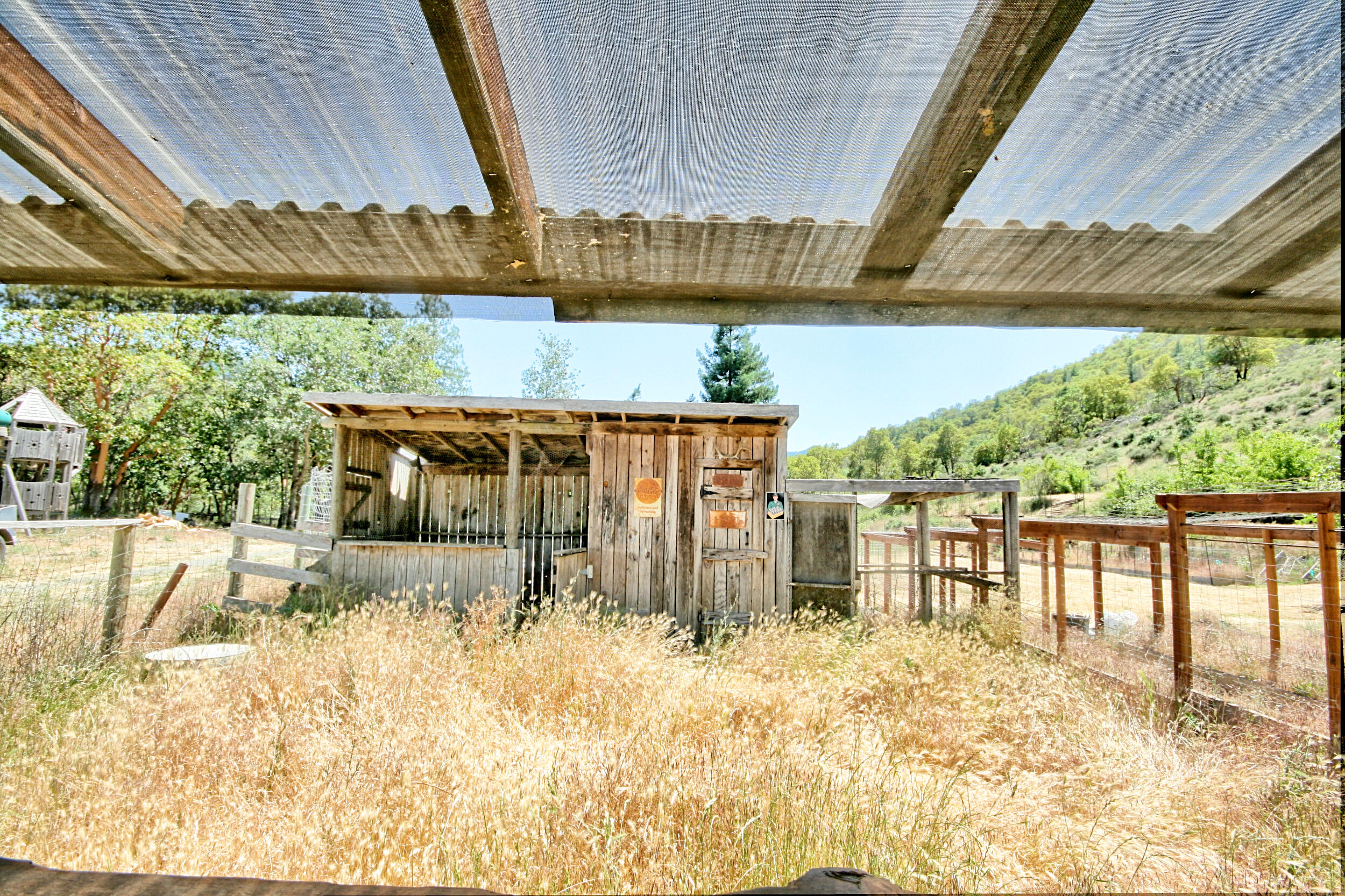 2231 Humbug Creek Road Jacksonville, OR 97530 - Photo 66 of 80 a view of a balcony with chairs and wooden floor