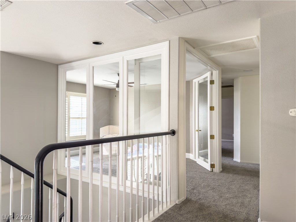 1842 Bogey Way Henderson, NV 89074 - Photo 21 of 25 Hall with dark colored carpet and baseboards