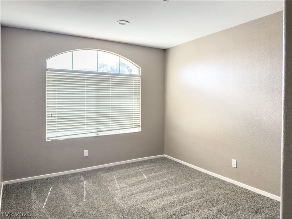 1842 Bogey Way Henderson, NV 89074 - Photo 23 of 25 Empty room featuring dark colored carpet and baseboards