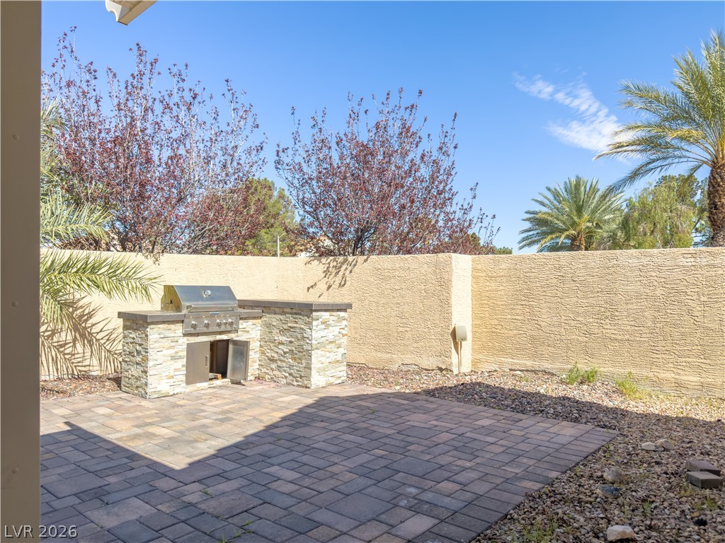 1842 Bogey Way Henderson, NV 89074 - Photo 9 of 25 Fenced backyard with area for grilling and a patio area