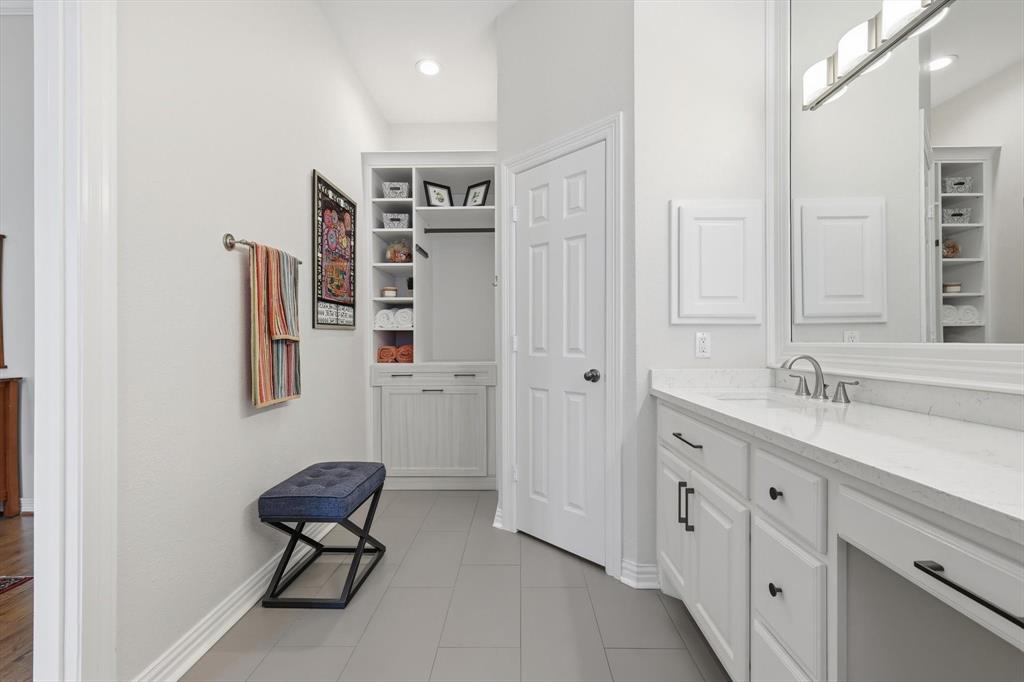 2619 Colby Street, Unit B Dallas, TX 75204 - Photo 15 of 34 a bathroom with a sink a toilet and a large mirror