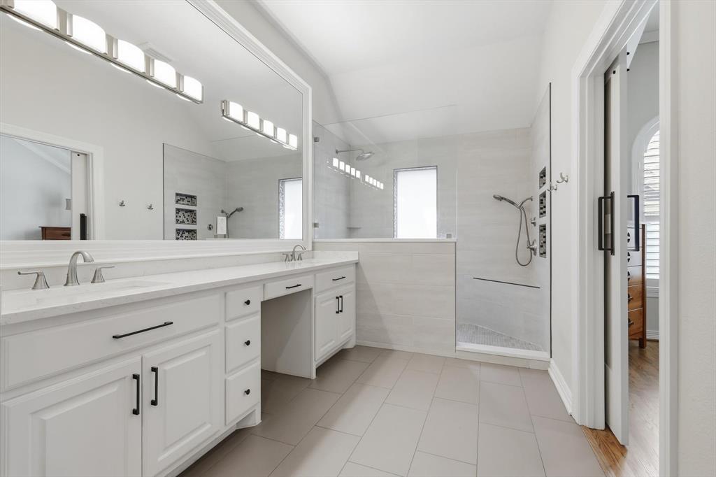 2619 Colby Street, Unit B Dallas, TX 75204 - Photo 17 of 34 a large white bathroom with a double vanity sink a mirror and a shower