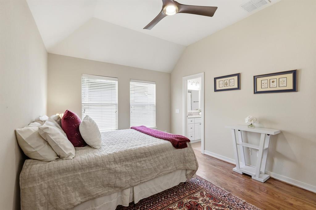 2619 Colby Street, Unit B Dallas, TX 75204 - Photo 19 of 34 a bedroom with a bed and wooden floor
