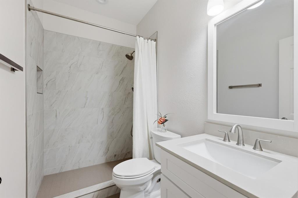 2619 Colby Street, Unit B Dallas, TX 75204 - Photo 24 of 34 a bathroom with a sink toilet and shower