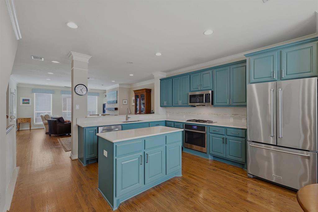2619 Colby Street, Unit B Dallas, TX 75204 - Photo 34 of 34 a kitchen with stainless steel appliances granite countertop a refrigerator a stove a sink dishwasher a oven with white cabinets and wooden floor