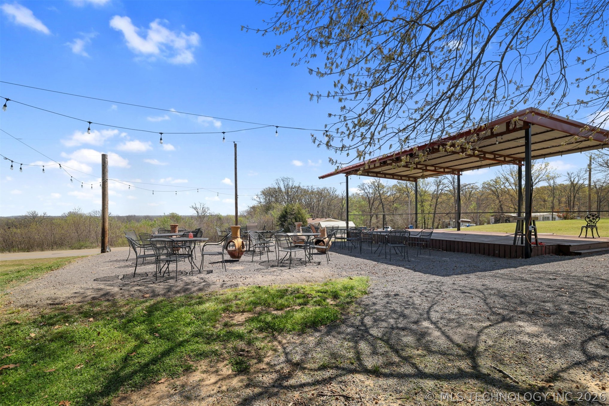 3565 Sawmill Road Caddo, OK 74729 - Photo 23 of 32 Expansive outdoor area featuring a gravel patio, string lighting, and a covered stage