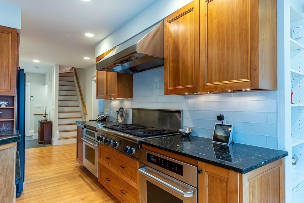 9 Blake Road Lexington, MA 02420 - Photo 16 of 41 a kitchen with stainless steel appliances granite countertop a stove a sink and a microwave