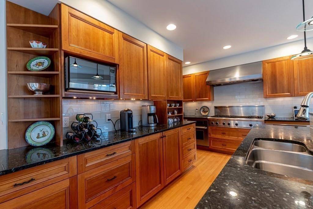 9 Blake Road Lexington, MA 02420 - Photo 20 of 41 a kitchen with stainless steel appliances granite countertop a stove a sink and a microwave