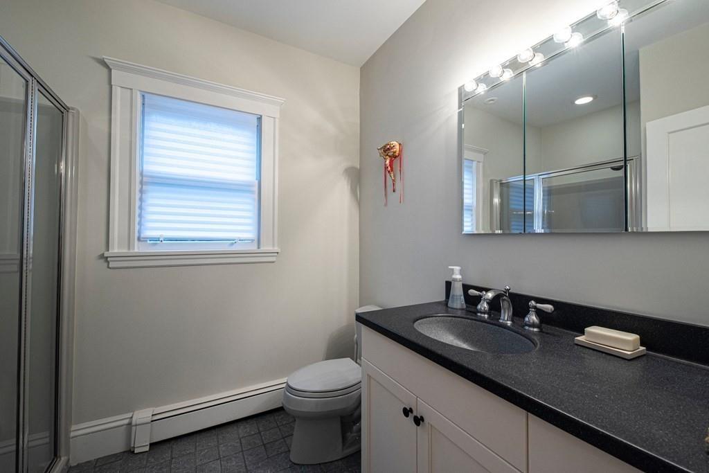 9 Blake Road Lexington, MA 02420 - Photo 24 of 41 a bathroom with a granite countertop sink a toilet and a mirror
