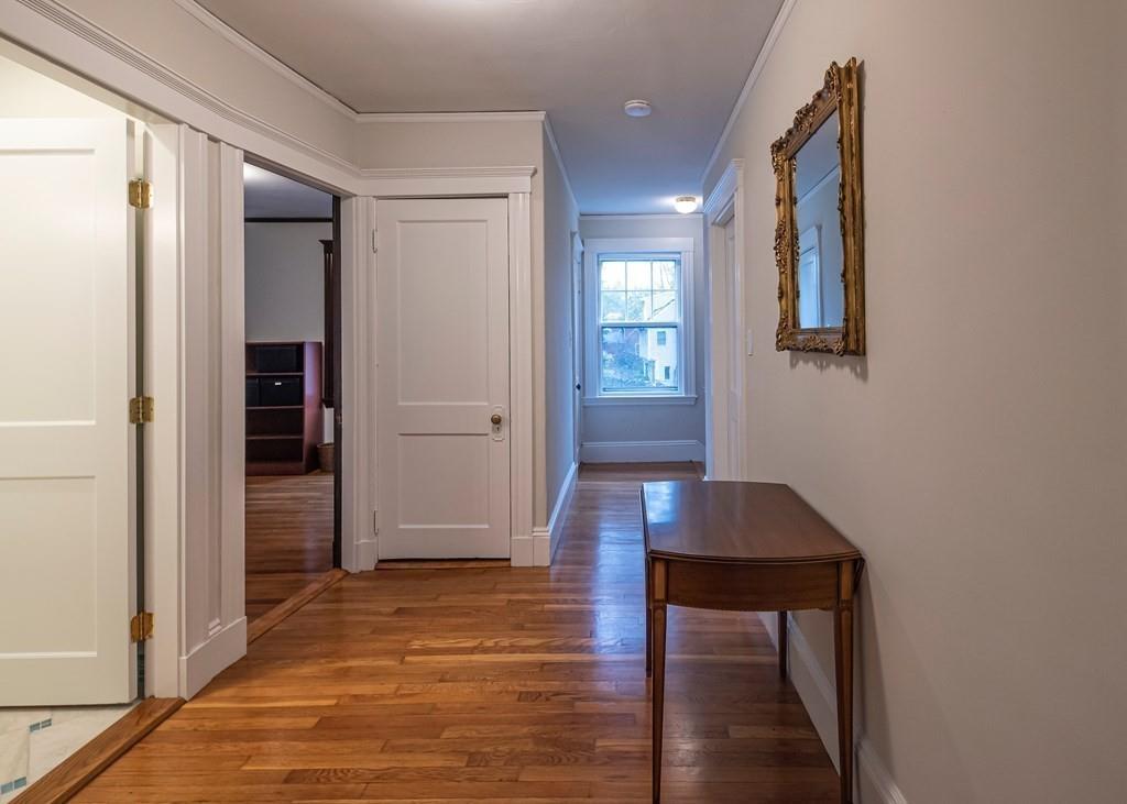 9 Blake Road Lexington, MA 02420 - Photo 26 of 41 a hallway with wooden floor table and chairs