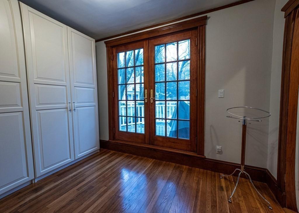 9 Blake Road Lexington, MA 02420 - Photo 28 of 41 an empty room with wooden floor and windows