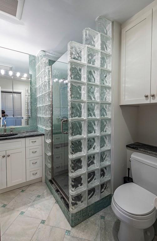 9 Blake Road Lexington, MA 02420 - Photo 33 of 41 a bathroom with a granite countertop sink a toilet and a shower