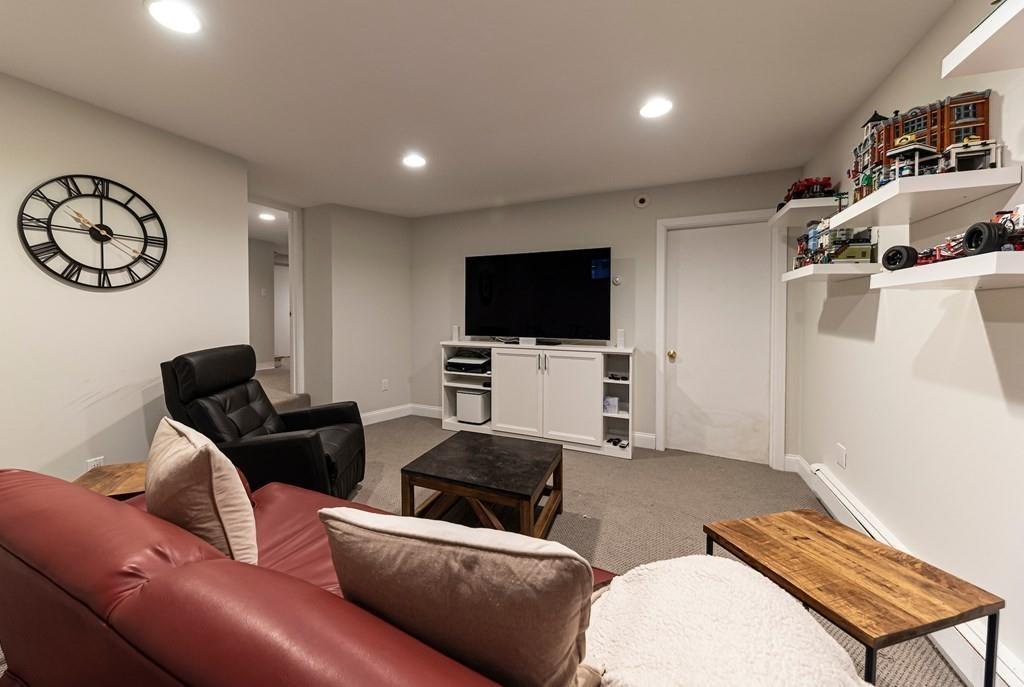 9 Blake Road Lexington, MA 02420 - Photo 35 of 41 a living room with furniture and a flat screen tv