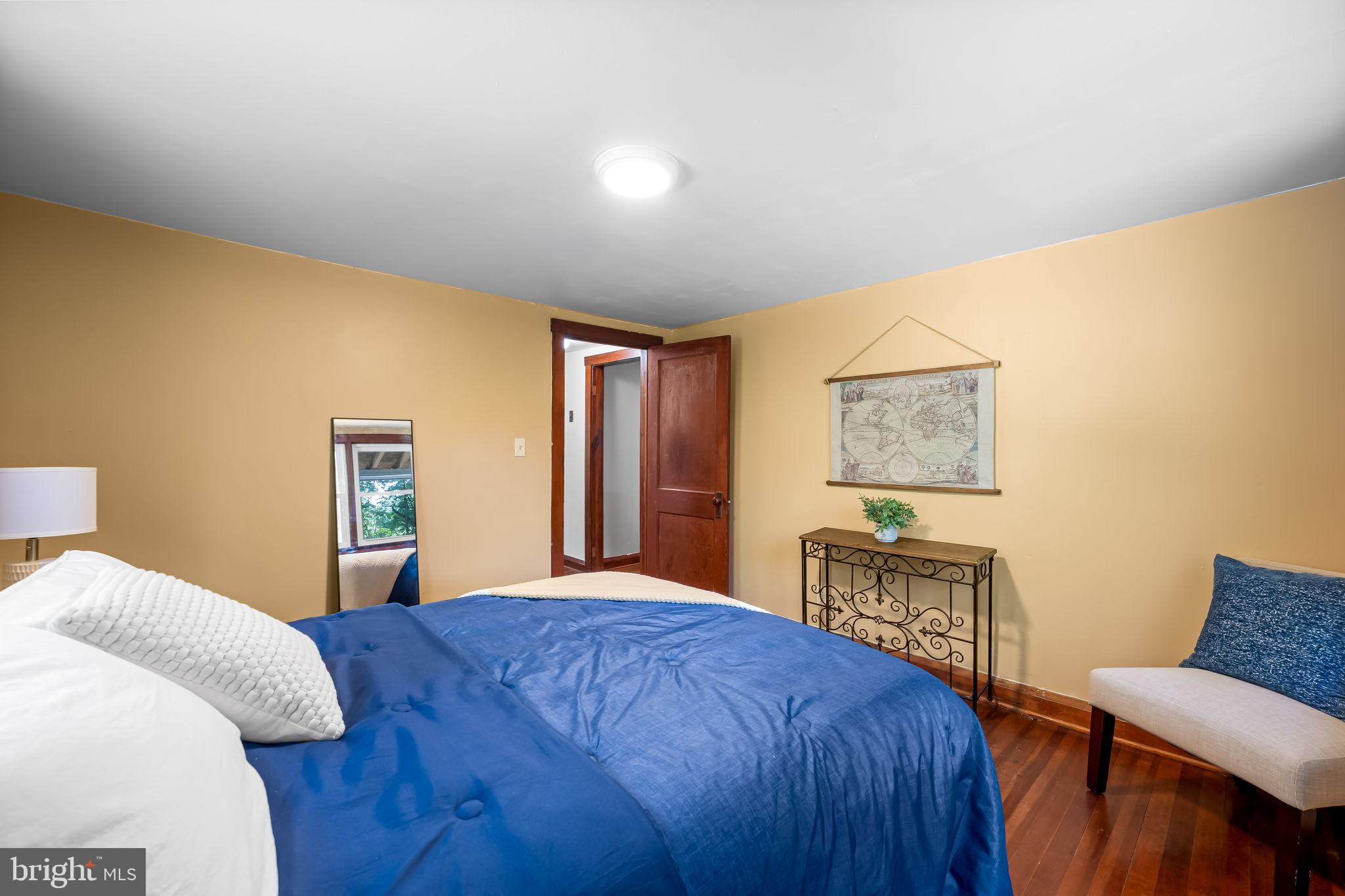 4831 Conowingo Road Darlington, MD 21034 - Photo 16 of 37 a bedroom with a bed and a dresser with wooden floor