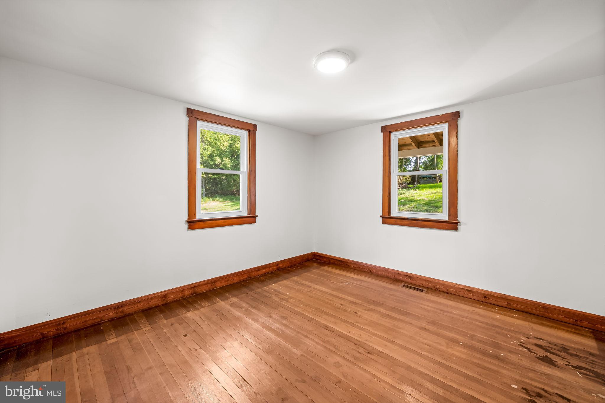 4831 Conowingo Road Darlington, MD 21034 - Photo 18 of 37 a view of an empty room with window and wooden floor