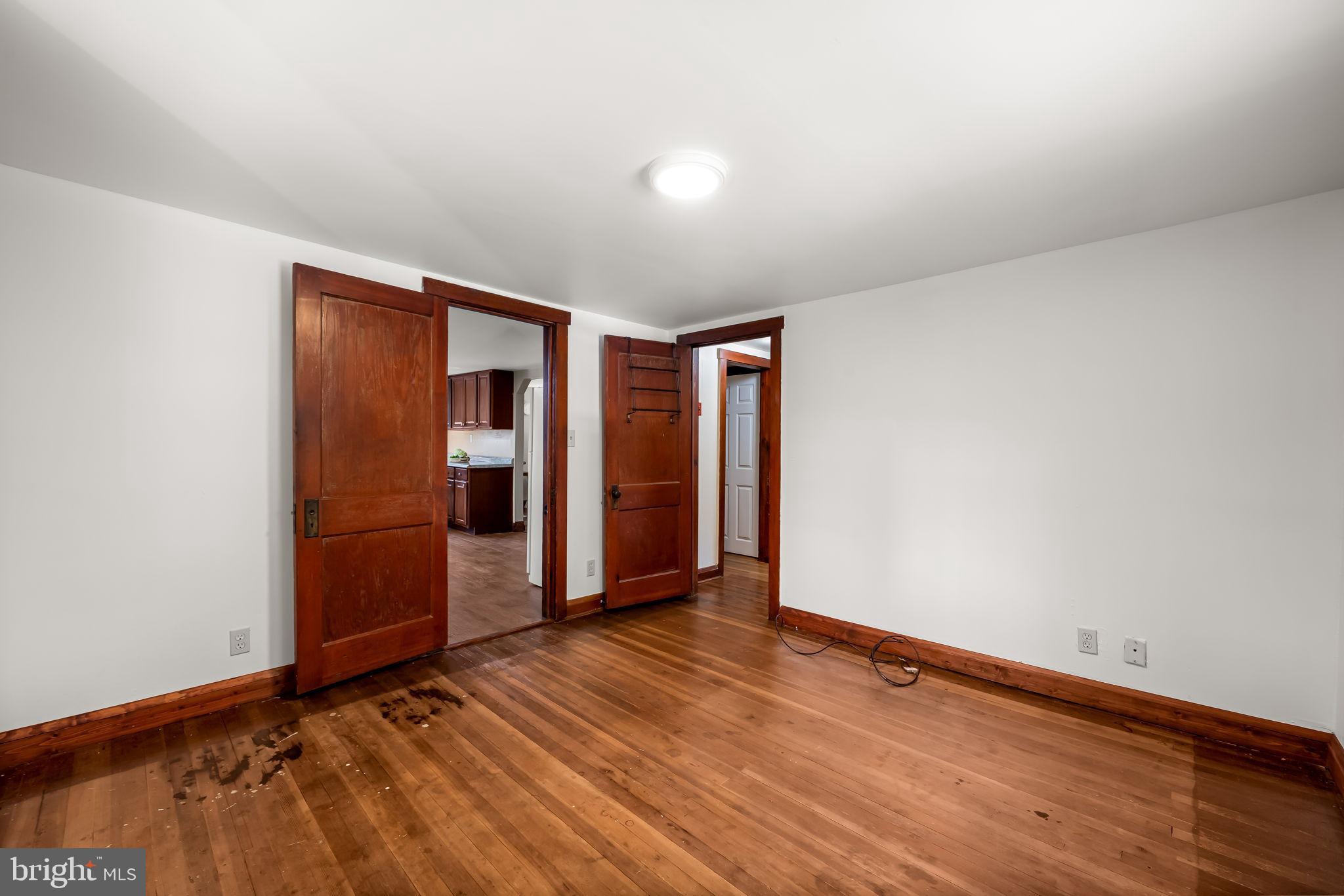 4831 Conowingo Road Darlington, MD 21034 - Photo 19 of 37 an empty room with wooden floor and closet