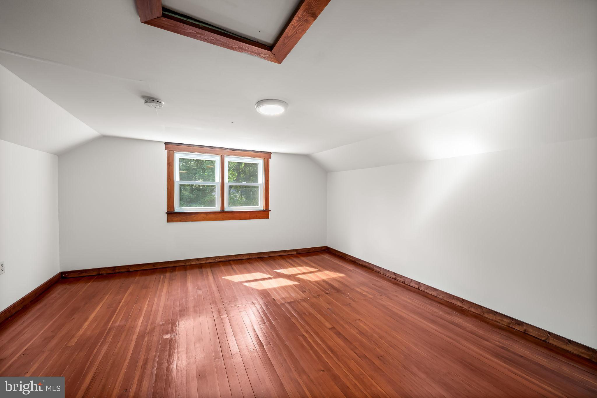 4831 Conowingo Road Darlington, MD 21034 - Photo 26 of 37 an empty room with wooden floor and windows