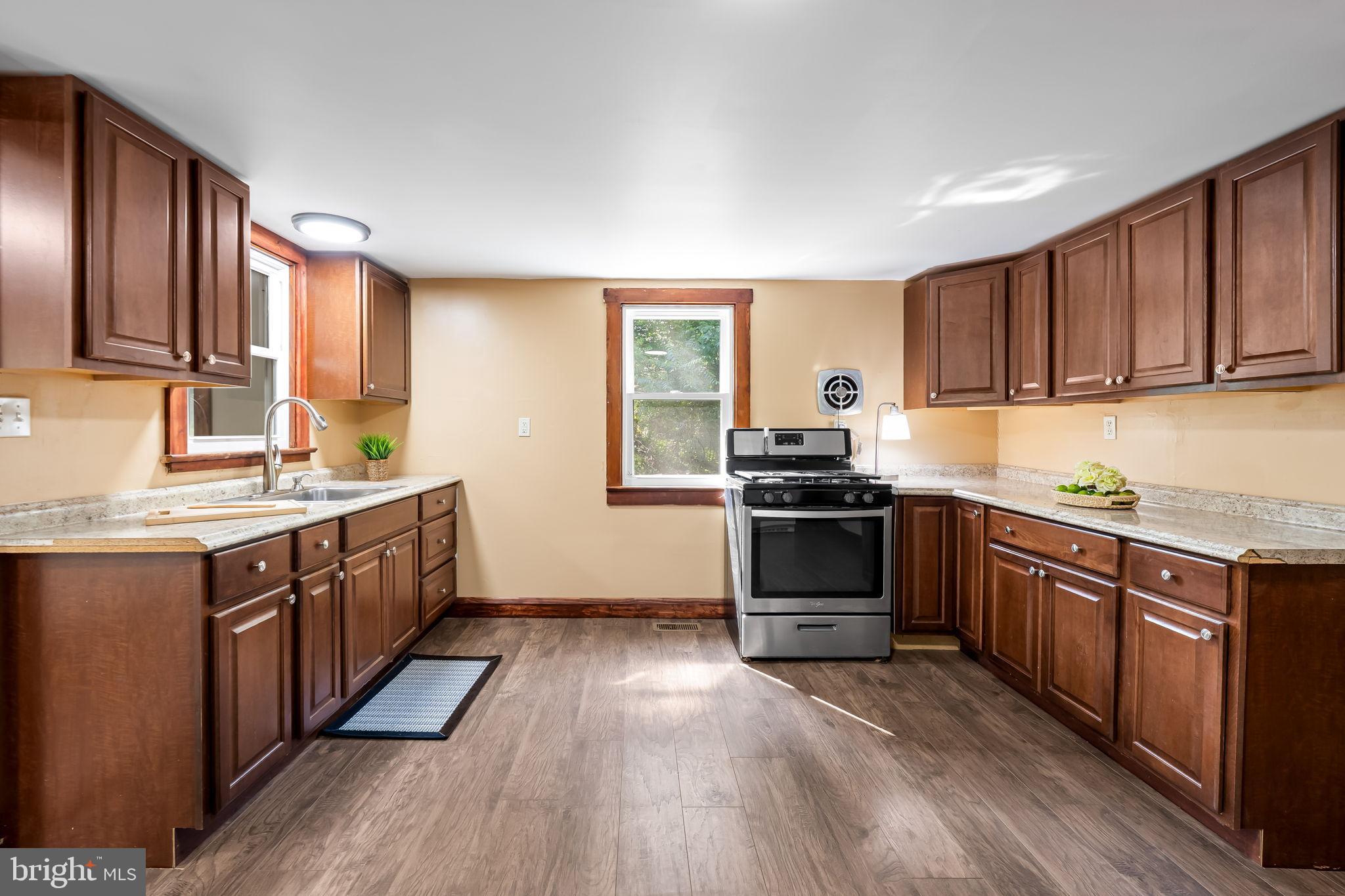 4831 Conowingo Road Darlington, MD 21034 - Photo 6 of 37 a kitchen with granite countertop wooden floors a sink and appliances