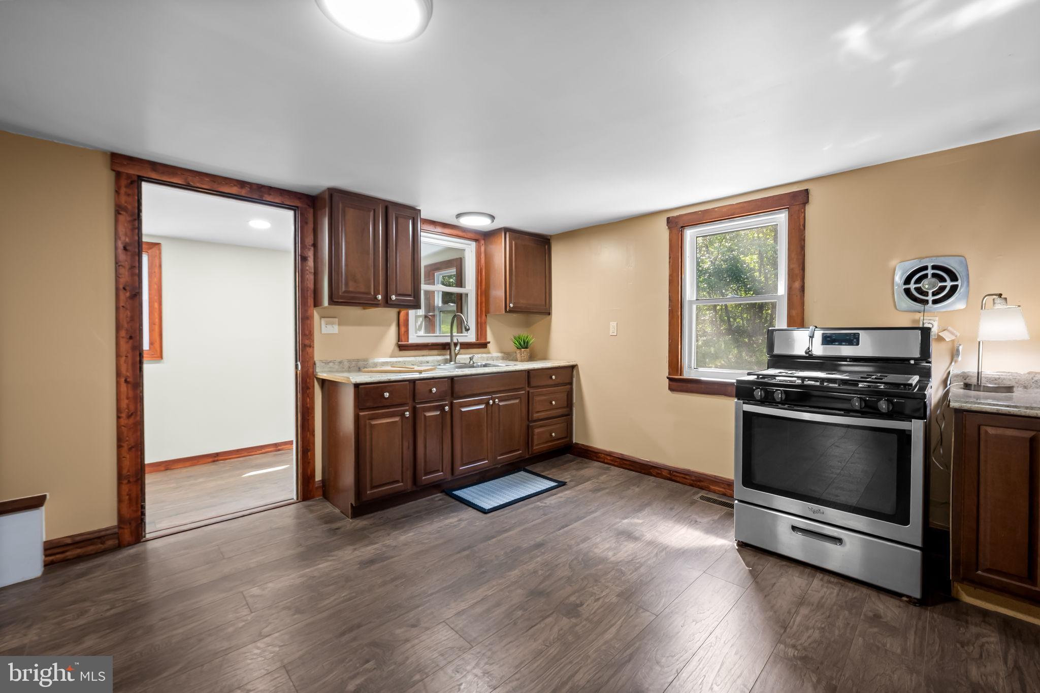 4831 Conowingo Road Darlington, MD 21034 - Photo 7 of 37 a kitchen with stainless steel appliances kitchen island granite countertop a stove a sink and a refrigerator