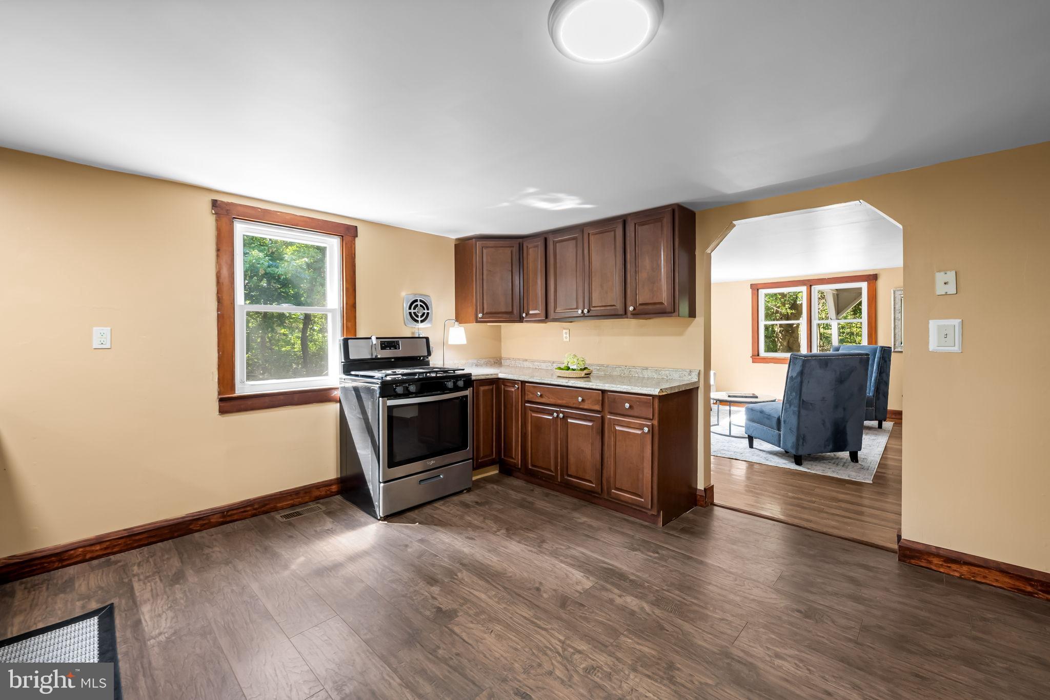 4831 Conowingo Road Darlington, MD 21034 - Photo 8 of 37 a kitchen with granite countertop a refrigerator and wooden cabinets