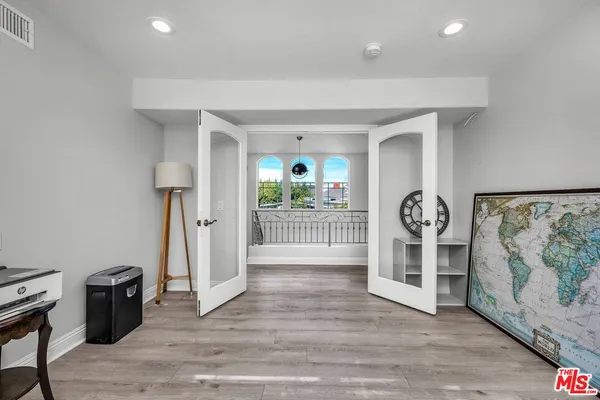 an empty room with wooden floor and a window