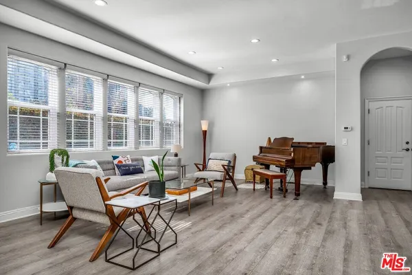 a living room with furniture and a wooden floor