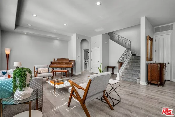 a living room with furniture and wooden floor