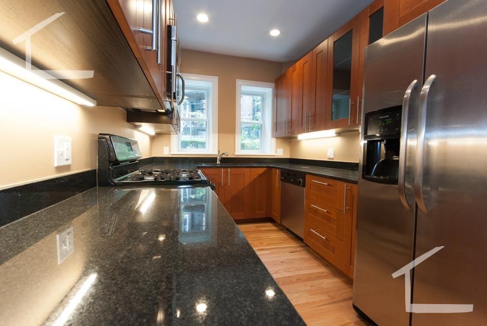 6 Lothian Road, Unit 1A Boston, MA 02135 - Photo 3 of 9 a kitchen with stainless steel appliances granite countertop a sink a stove top oven a counter space and cabinets