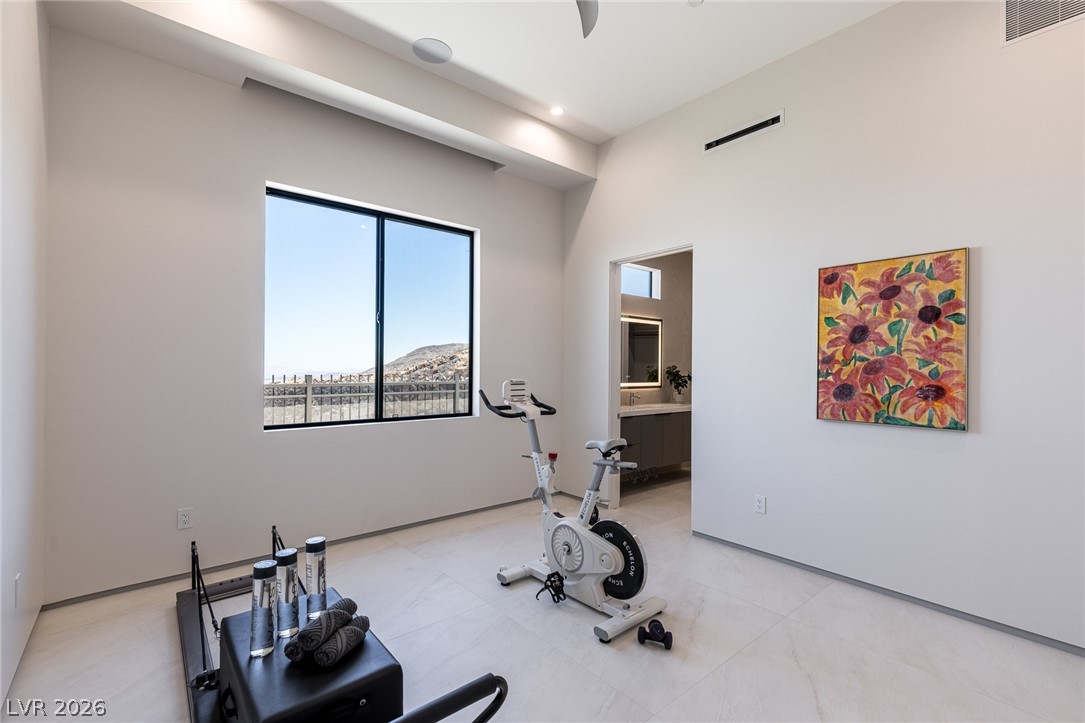 563 Grand Rim Drive Henderson, NV 89012 - Photo 38 of 70 Well-lit exercise room boasts a panoramic view and convenient access to a modern bathroom.