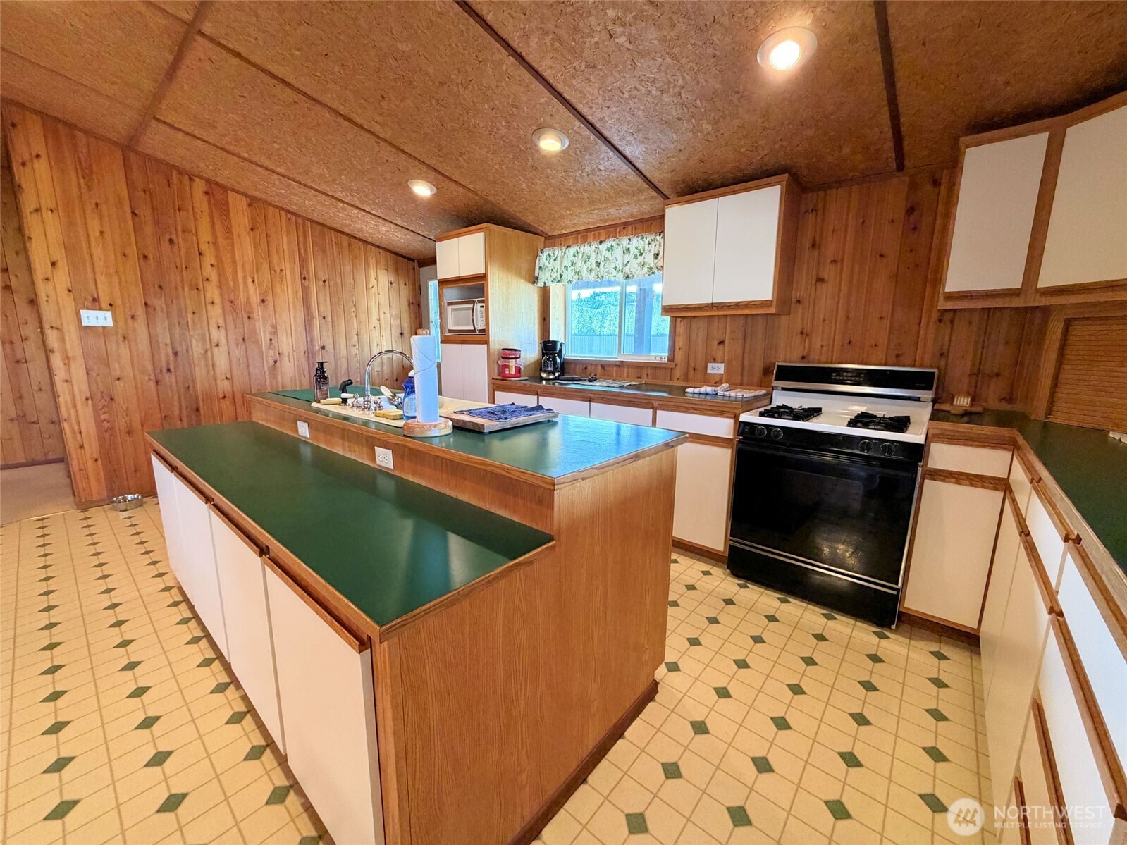 41238 Sterling Valley Road North Lincoln, WA 99147 - Photo 6 of 39 a kitchen with sink a stove and cabinets