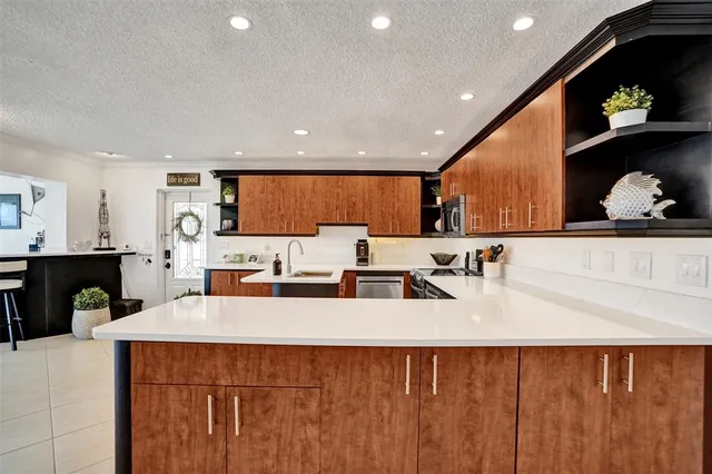 a large kitchen with stainless steel appliances a large counter top
