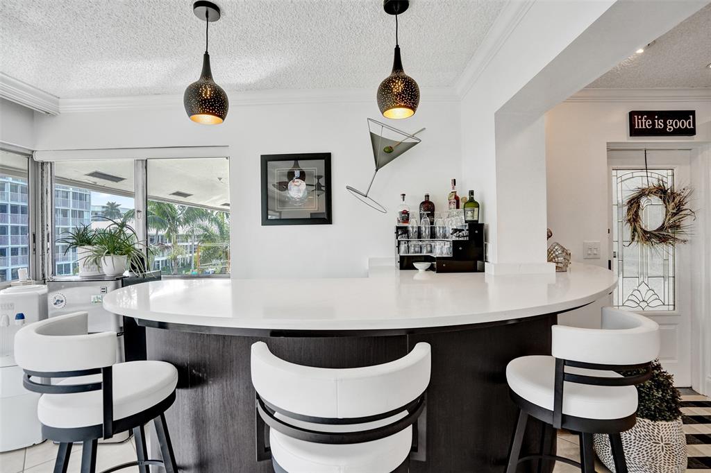 3090 Northeast 48th Street, Unit 316 Fort Lauderdale, FL 33308 - Photo 15 of 49 a table and chairs in a room