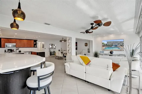 a living room with furniture and kitchen view