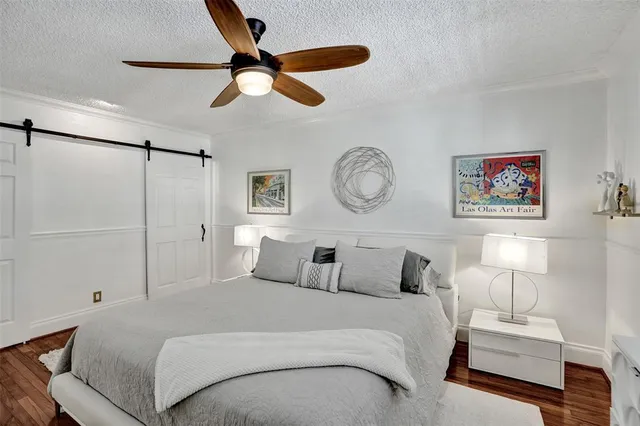 a bedroom with a large bed and a chandelier