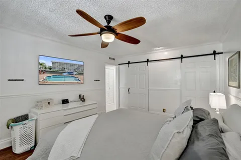 a bedroom with a bed and a painting on the wall